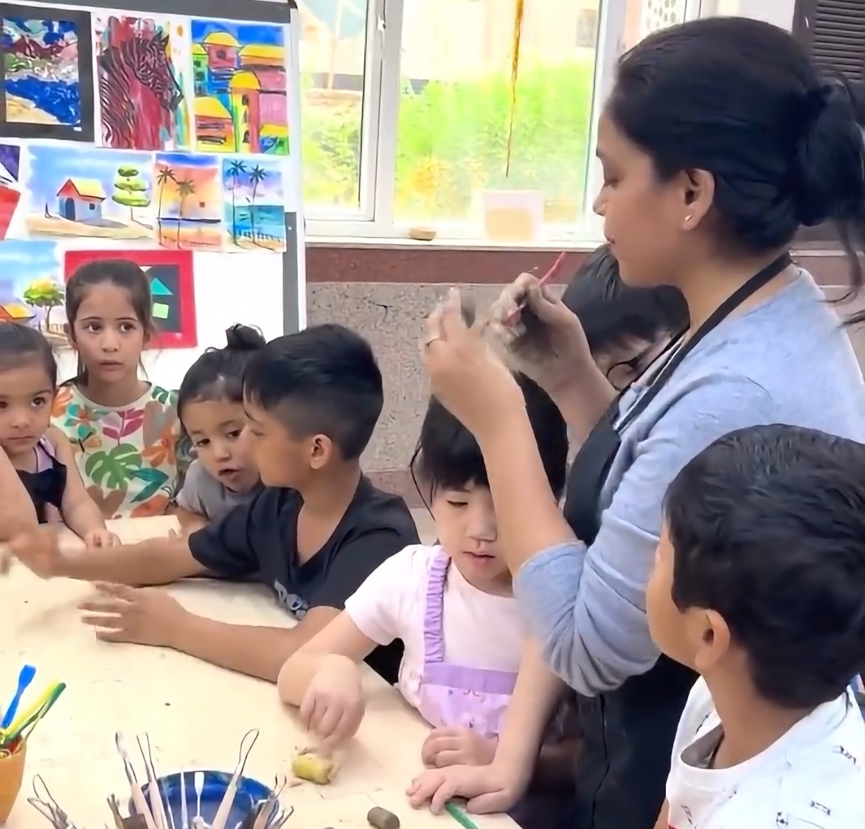 Bulbul Chauhan guiding children during an art class